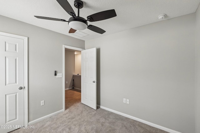 7802 Merchants Way, Jacksonville, FL 32222 - unfurnished bedroom featuring light carpet, baseboards, a textured ceiling, and a ceiling fan