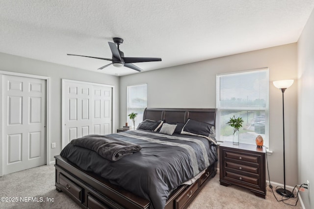 7802 Merchants Way, Jacksonville, FL 32222 - bedroom with multiple closets, a textured ceiling, baseboards, a ceiling fan, and light carpet