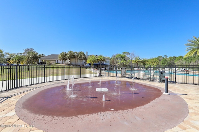 surrounding community with a swimming pool and fence