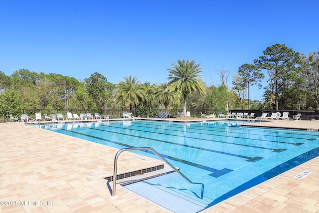 pool featuring a patio and fence