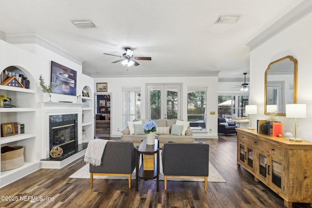 living area with a fireplace, dark wood-style floors, ceiling fan, and visible vents