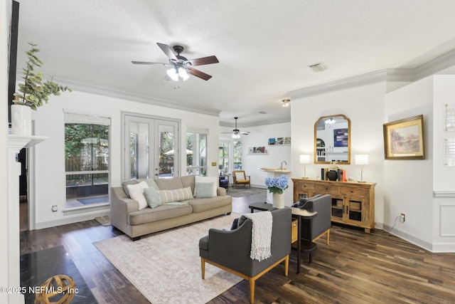 living room featuring a ceiling fan, wood finished floors, crown molding, and visible vents