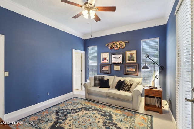 living room featuring ornamental molding, a textured ceiling, baseboards, and ceiling fan