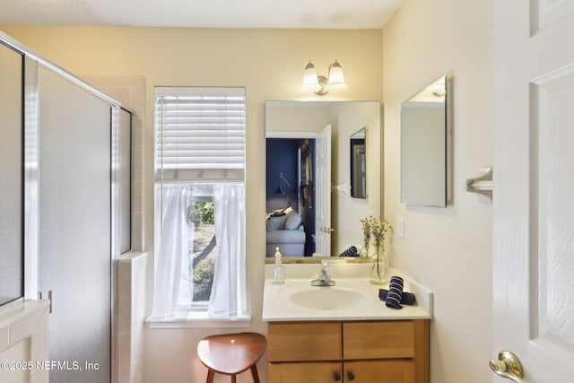 bathroom with a stall shower and vanity