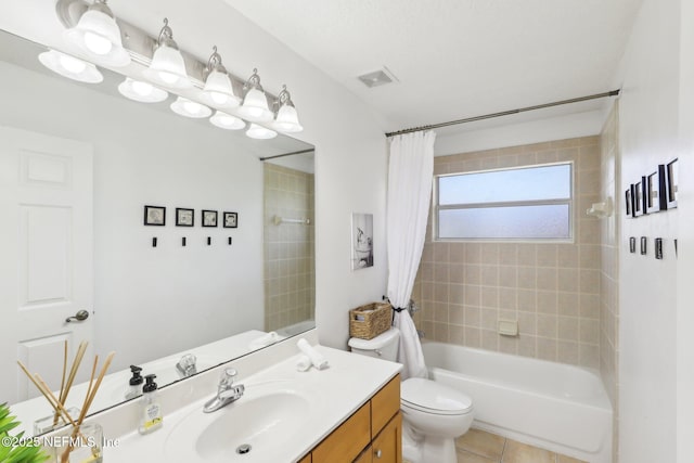 bathroom featuring tile patterned floors, toilet, vanity, shower / bath combo with shower curtain, and visible vents