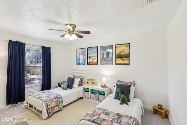 carpeted bedroom with baseboards, a textured ceiling, and a ceiling fan