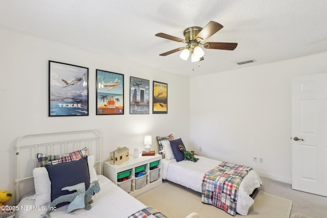 bedroom featuring light carpet, baseboards, visible vents, and ceiling fan