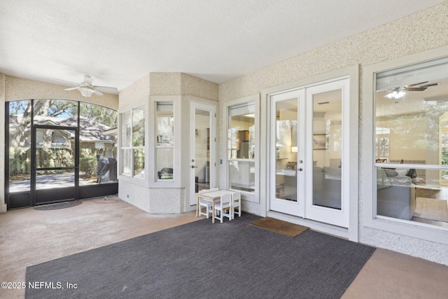 unfurnished sunroom with french doors, carpet floors, and a textured ceiling