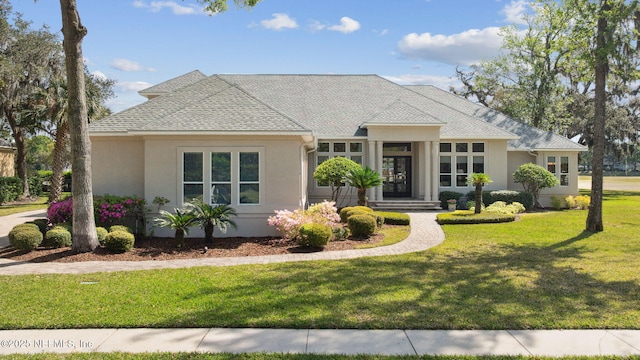 1193 Queens Harbor Blvd, Jacksonville, FL 32225 - view of front of house featuring stucco siding, a shingled roof, and a front lawn