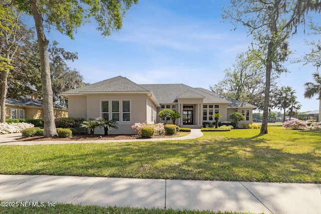 1193 Queens Harbor Blvd, Jacksonville, FL 32225 - prairie-style home featuring a front yard, stucco siding, and roof with shingles