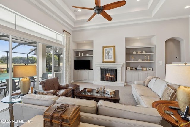 1193 Queens Harbor Blvd, Jacksonville, FL 32225 - living room featuring a fireplace, arched walkways, ceiling fan, and built in shelves