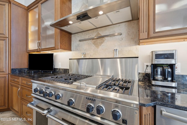 1193 Queens Harbor Blvd, Jacksonville, FL 32225 - kitchen with dark stone countertops, range hood, high end stainless steel range, glass insert cabinets, and brown cabinets