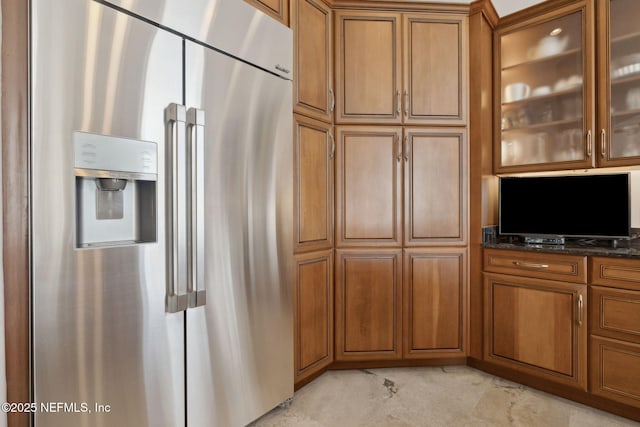 1193 Queens Harbor Blvd, Jacksonville, FL 32225 - kitchen with brown cabinets, high end fridge, glass insert cabinets, and dark stone countertops