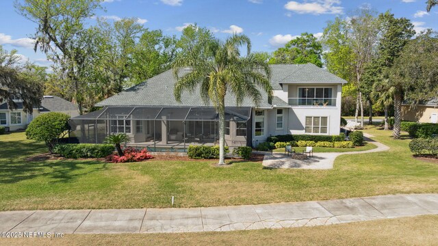 1193 Queens Harbor Blvd, Jacksonville, FL 32225 - back of property featuring glass enclosure, a lawn, stucco siding, and a patio area
