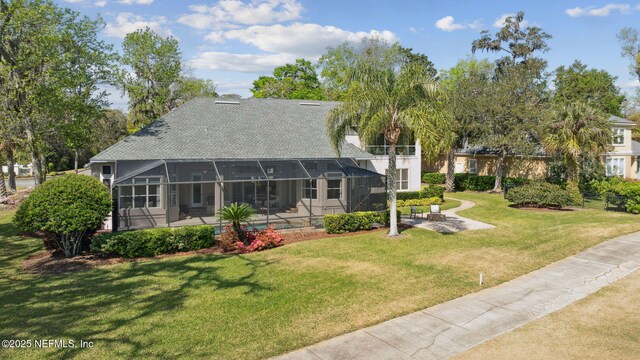 1193 Queens Harbor Blvd, Jacksonville, FL 32225 - back of property with a shingled roof, a lawn, a lanai, and a patio