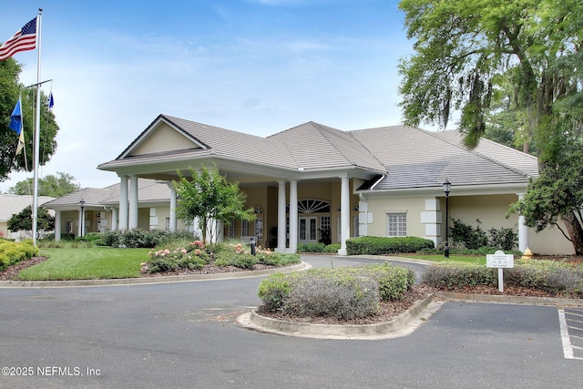 1193 Queens Harbor Blvd, Jacksonville, FL 32225 - view of front of home with a tile roof, stucco siding, and a front lawn