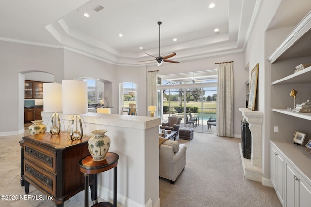 1193 Queens Harbor Blvd, Jacksonville, FL 32225 - living area with a tray ceiling, ceiling fan, arched walkways, and crown molding