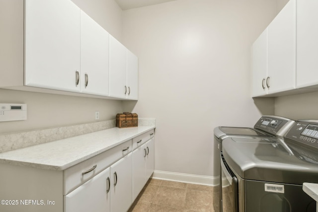 1193 Queens Harbor Blvd, Jacksonville, FL 32225 - laundry area with light tile patterned flooring, cabinet space, baseboards, and separate washer and dryer