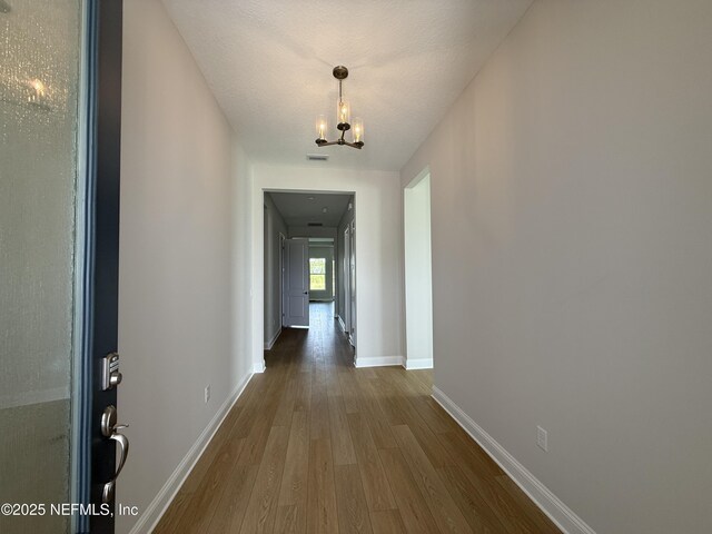 294 Lamego Ln, Saint Augustine, FL 32095 - hall with dark wood-type flooring and a chandelier