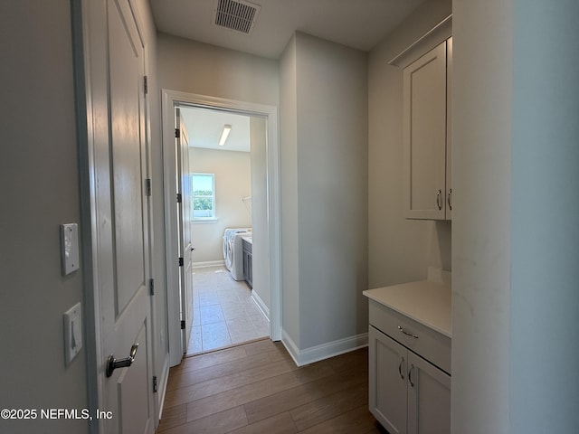 294 Lamego Ln, Saint Augustine, FL 32095 - corridor with independent washer and dryer and wood finished floors