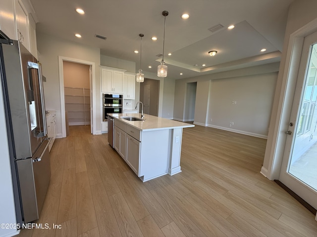 294 Lamego Ln, Saint Augustine, FL 32095 - kitchen featuring appliances with stainless steel finishes, light wood finished floors, light countertops, white cabinets, and recessed lighting