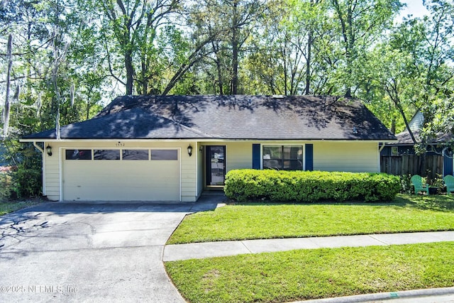 7552 Pottsburg Landing Dr, Jacksonville, FL 32216 - ranch-style house with concrete driveway, fence, an attached garage, a front yard, and a shingled roof