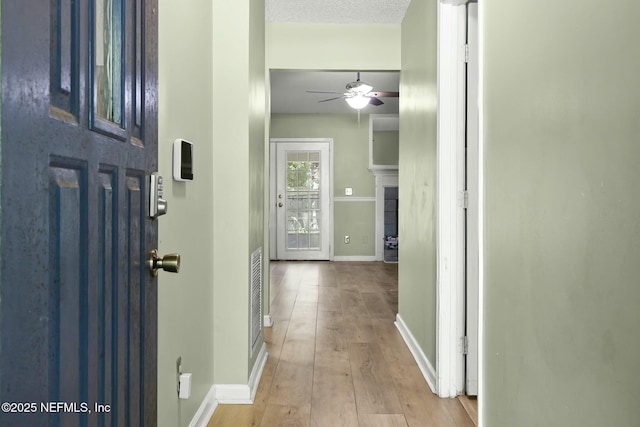 7552 Pottsburg Landing Dr, Jacksonville, FL 32216 - entryway featuring a ceiling fan, a textured ceiling, baseboards, and wood finished floors