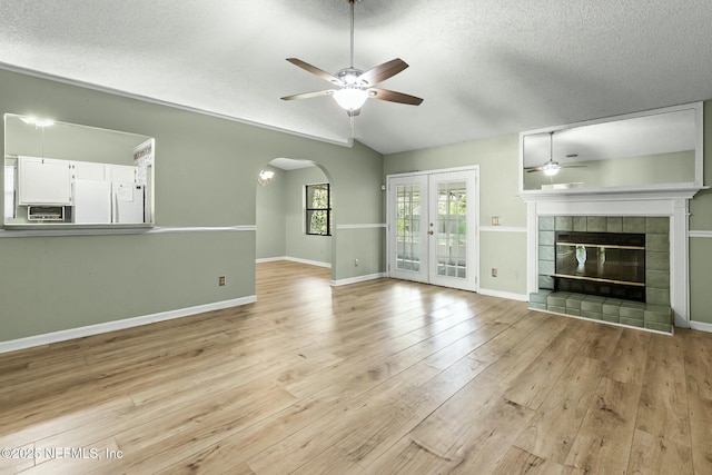 7552 Pottsburg Landing Dr, Jacksonville, FL 32216 - unfurnished living room with lofted ceiling, a textured ceiling, a ceiling fan, and light wood finished floors