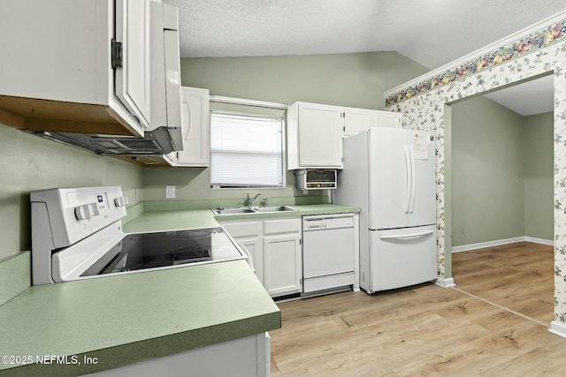 7552 Pottsburg Landing Dr, Jacksonville, FL 32216 - kitchen with lofted ceiling, light wood-type flooring, white appliances, a sink, and white cabinets