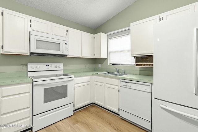 7552 Pottsburg Landing Dr, Jacksonville, FL 32216 - kitchen featuring white appliances, white cabinets, light countertops, and a sink