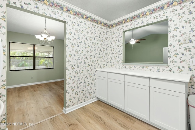 7552 Pottsburg Landing Dr, Jacksonville, FL 32216 - bathroom featuring wallpapered walls, ceiling fan with notable chandelier, baseboards, and wood finished floors
