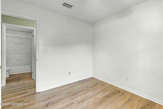 7552 Pottsburg Landing Dr, Jacksonville, FL 32216 - unfurnished bedroom with baseboards, visible vents, and light wood-type flooring