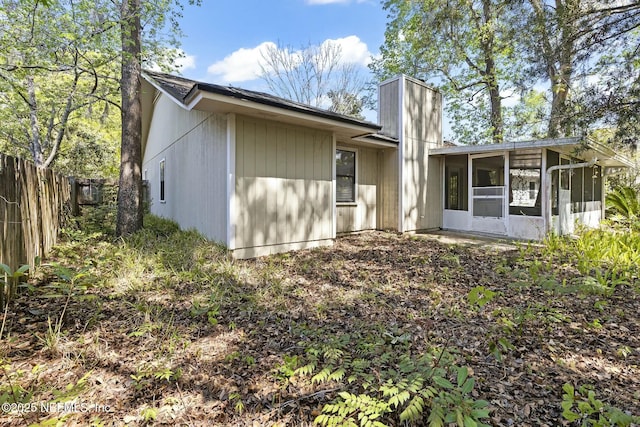 7552 Pottsburg Landing Dr, Jacksonville, FL 32216 - view of front of house featuring a sunroom, fence, and a chimney