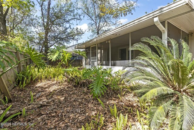 7552 Pottsburg Landing Dr, Jacksonville, FL 32216 - view of yard featuring a fenced backyard and a sunroom