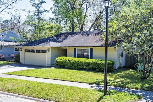 7552 Pottsburg Landing Dr, Jacksonville, FL 32216 - single story home featuring fence, a garage, concrete driveway, a front yard, and a shingled roof
