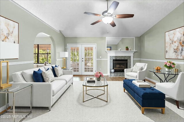 7552 Pottsburg Landing Dr, Jacksonville, FL 32216 - living area featuring vaulted ceiling, french doors, a ceiling fan, wood finished floors, and arched walkways