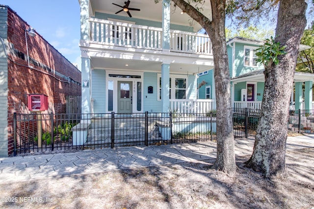 view of front of property with a fenced front yard, a porch, and ceiling fan