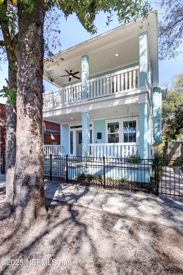view of front facade featuring a balcony and fence