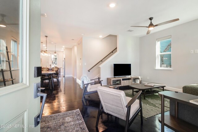 living room with baseboards, stairway, recessed lighting, and a ceiling fan