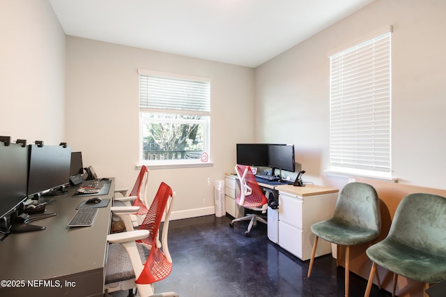 office with concrete floors and baseboards