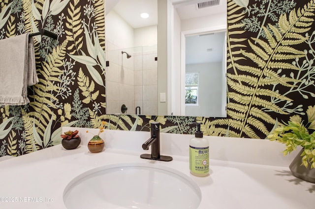 bathroom featuring a stall shower, visible vents, and vanity