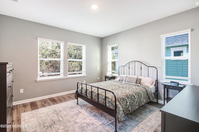 bedroom featuring baseboards and wood finished floors