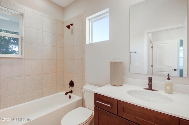 bathroom with toilet, vanity, and shower / bathtub combination