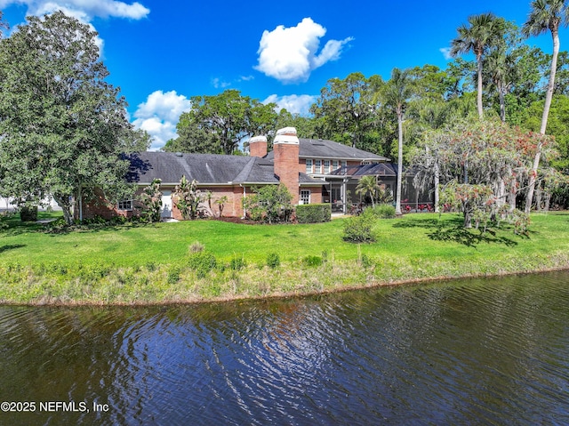 6260 Highlands Ct, Ponte Vedra Beach, FL 32082 - back of house with a water view, a chimney, a yard, and brick siding