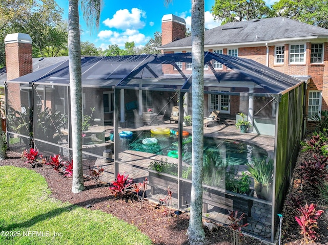 6260 Highlands Ct, Ponte Vedra Beach, FL 32082 - rear view of property with a chimney, brick siding, a patio, a lanai, and an outdoor pool