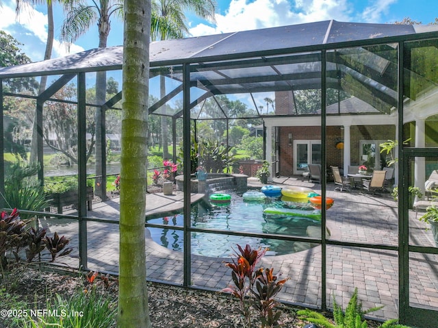 6260 Highlands Ct, Ponte Vedra Beach, FL 32082 - back of house featuring glass enclosure, a patio area, brick siding, and a pool with connected hot tub