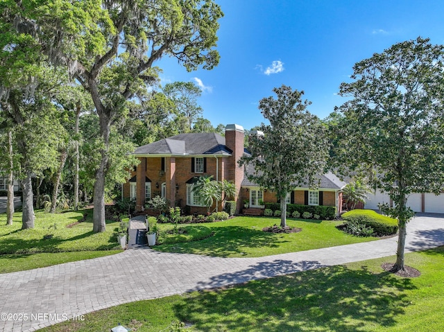 6260 Highlands Ct, Ponte Vedra Beach, FL 32082 - view of front of property featuring brick siding, a front yard, and a chimney
