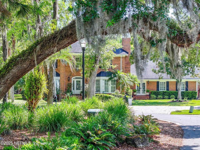 6260 Highlands Ct, Ponte Vedra Beach, FL 32082 - view of front of home featuring french doors, brick siding, and a chimney