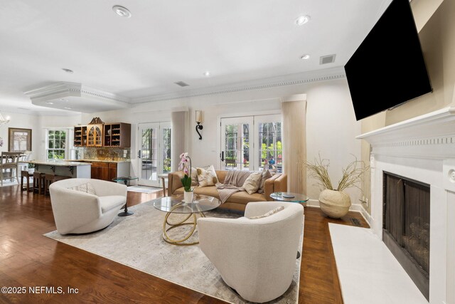 6260 Highlands Ct, Ponte Vedra Beach, FL 32082 - living area with ornamental molding, a fireplace with flush hearth, healthy amount of natural light, recessed lighting, and dark wood-style floors