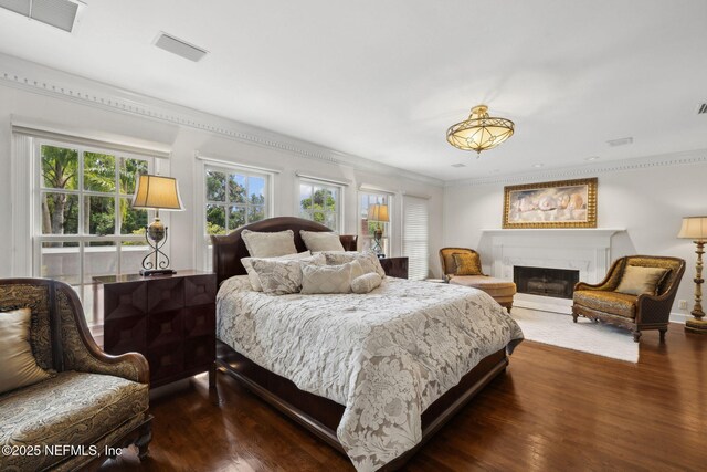 6260 Highlands Ct, Ponte Vedra Beach, FL 32082 - bedroom with dark wood finished floors, a fireplace, and ornamental molding